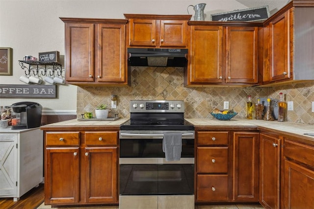 12329 SW 9th Ter, Yukon, OK 73099 - kitchen featuring double oven range, range hood, tile countertops, and backsplash