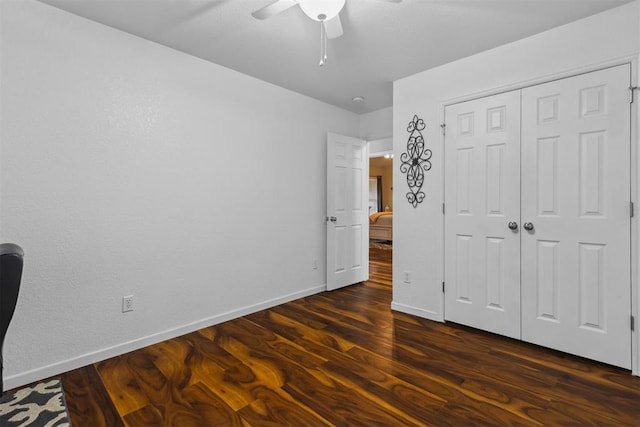12329 SW 9th Ter, Yukon, OK 73099 - unfurnished bedroom with baseboards, dark wood finished floors, a ceiling fan, and a closet