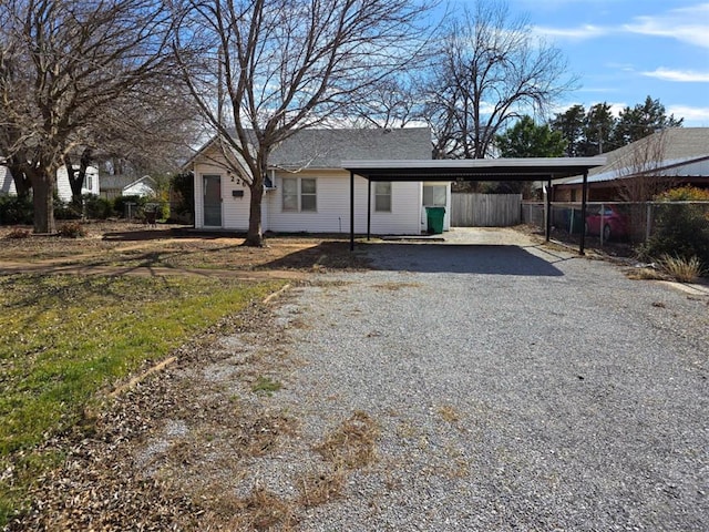 226 E Iowa St, Walters, OK 73572 - back of property with gravel driveway and a detached carport