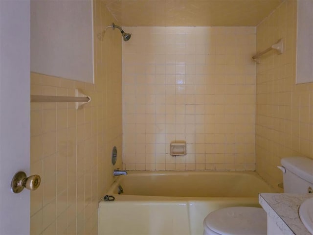 226 E Iowa St, Walters, OK 73572 - full bathroom featuring toilet, vanity, shower / bathtub combination, and tile walls