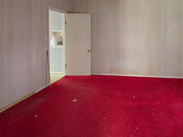 226 E Iowa St, Walters, OK 73572 - unfurnished room featuring wooden walls and carpet