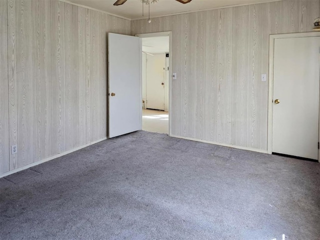 226 E Iowa St, Walters, OK 73572 - unfurnished room with a ceiling fan, carpet floors, and wood walls