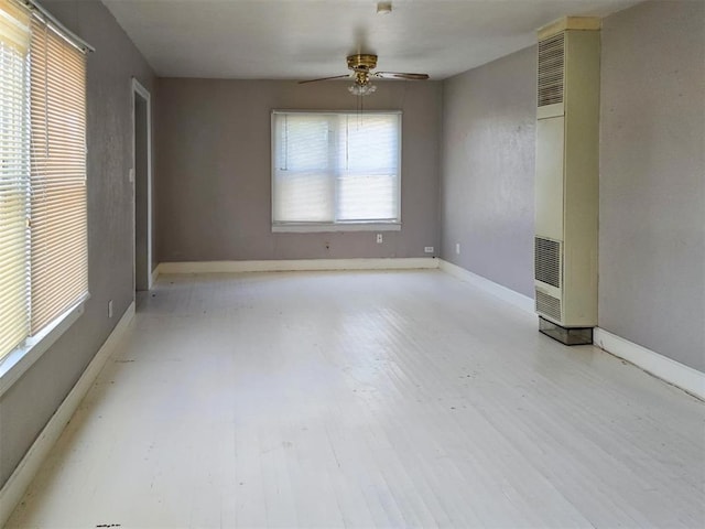 226 E Iowa St, Walters, OK 73572 - unfurnished room with a heating unit, a ceiling fan, wood finished floors, and baseboards