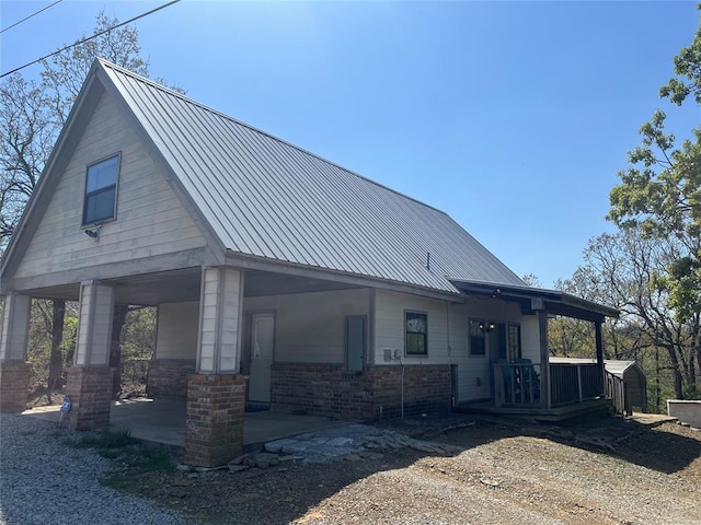 216 N Bk 1600 Rd, Stigler, OK 74462 - view of side of home featuring covered porch and brick siding