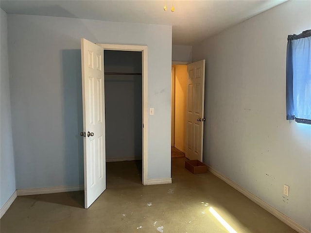 216 N Bk 1600 Rd, Stigler, OK 74462 - unfurnished bedroom featuring baseboards, concrete floors, and a closet
