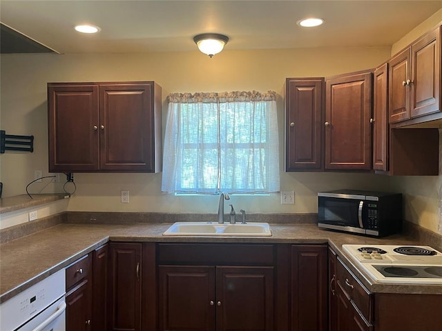 216 N Bk 1600 Rd, Stigler, OK 74462 - kitchen with stainless steel microwave, a sink, white electric stovetop, dark countertops, and dark brown cabinetry