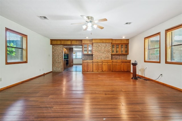 1317 S 58th St, Duncan, OK 73534 - unfurnished living room featuring dark wood-type flooring, ceiling fan, and baseboards