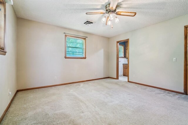 1317 S 58th St, Duncan, OK 73534 - carpeted spare room featuring a textured ceiling, ceiling fan, and baseboards