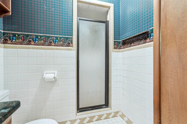 1317 S 58th St, Duncan, OK 73534 - bathroom with toilet, tile walls, a shower stall, wallpapered walls, and vanity