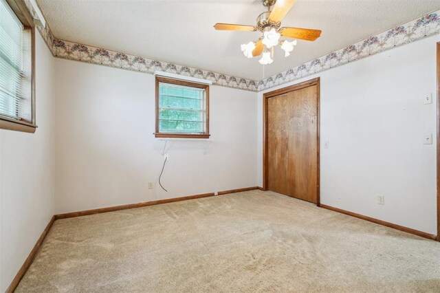 1317 S 58th St, Duncan, OK 73534 - carpeted spare room featuring baseboards and ceiling fan