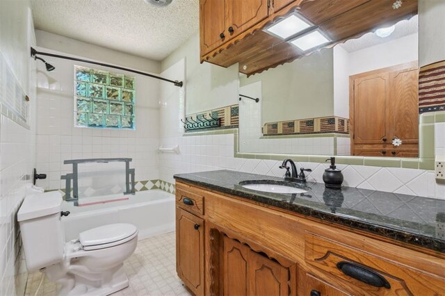 1317 S 58th St, Duncan, OK 73534 - bathroom featuring toilet, bathtub / shower combination, vanity, tile walls, and tile patterned floors