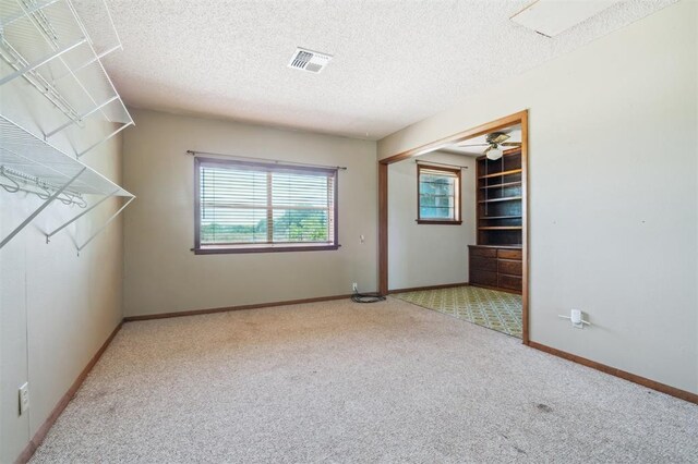 1317 S 58th St, Duncan, OK 73534 - carpeted spare room with a textured ceiling, baseboards, and a ceiling fan