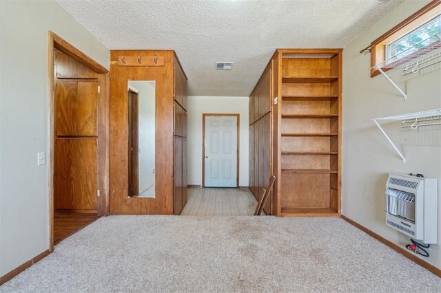 1317 S 58th St, Duncan, OK 73534 - interior space featuring heating unit, light carpet, a textured ceiling, and baseboards