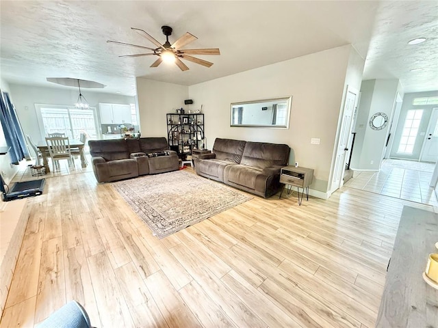 9977 Birkenhead Ct, Yukon, OK 73099 - living area featuring a ceiling fan and light wood finished floors