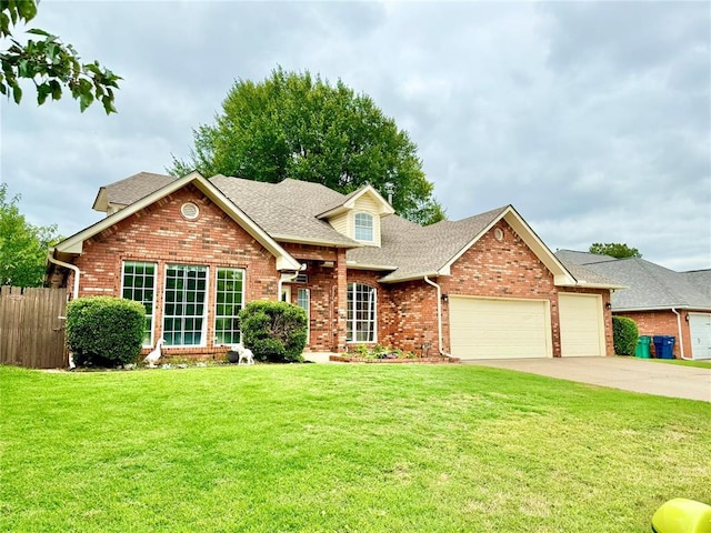 9977 Birkenhead Ct, Yukon, OK 73099 - traditional-style home featuring brick siding, an attached garage, roof with shingles, and driveway