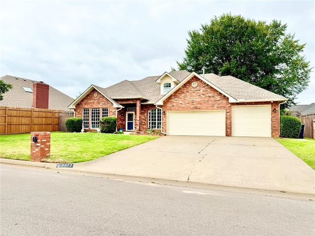 9977 Birkenhead Ct, Yukon, OK 73099 - traditional-style home with brick siding, a garage, driveway, and a shingled roof
