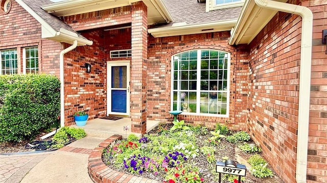 9977 Birkenhead Ct, Yukon, OK 73099 - entrance to property featuring brick siding and a shingled roof