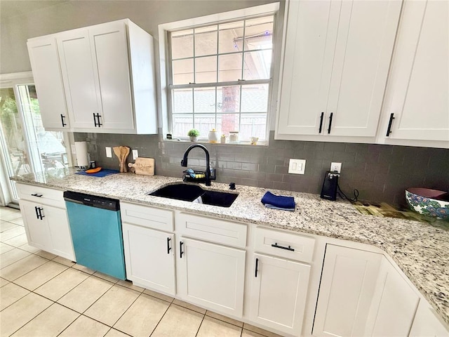 9977 Birkenhead Ct, Yukon, OK 73099 - kitchen with dishwasher, decorative backsplash, light tile patterned floors, and white cabinetry