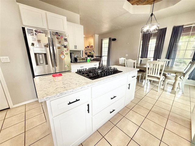 9977 Birkenhead Ct, Yukon, OK 73099 - kitchen with stainless steel refrigerator with ice dispenser, black gas stovetop, light tile patterned flooring, pendant lighting, and white cabinetry