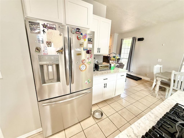 9977 Birkenhead Ct, Yukon, OK 73099 - kitchen featuring stainless steel fridge with ice dispenser, white cabinets, light tile patterned floors, and light stone counters
