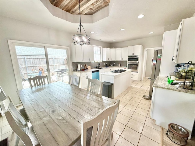 9977 Birkenhead Ct, Yukon, OK 73099 - dining space with light tile patterned floors, recessed lighting, a chandelier, wood ceiling, and a raised ceiling