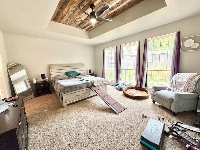 9977 Birkenhead Ct, Yukon, OK 73099 - carpeted bedroom featuring a raised ceiling, ceiling fan, and wooden ceiling