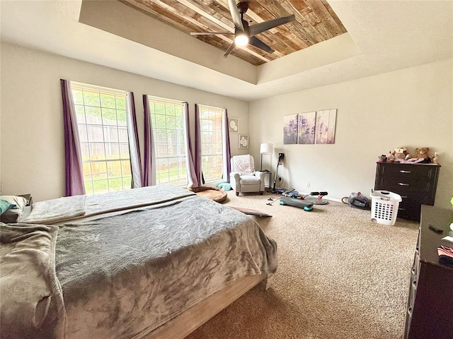 9977 Birkenhead Ct, Yukon, OK 73099 - carpeted bedroom with a raised ceiling, wooden ceiling, and ceiling fan