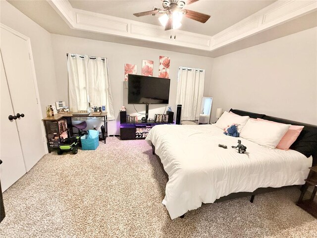 9977 Birkenhead Ct, Yukon, OK 73099 - carpeted bedroom with a raised ceiling and ceiling fan