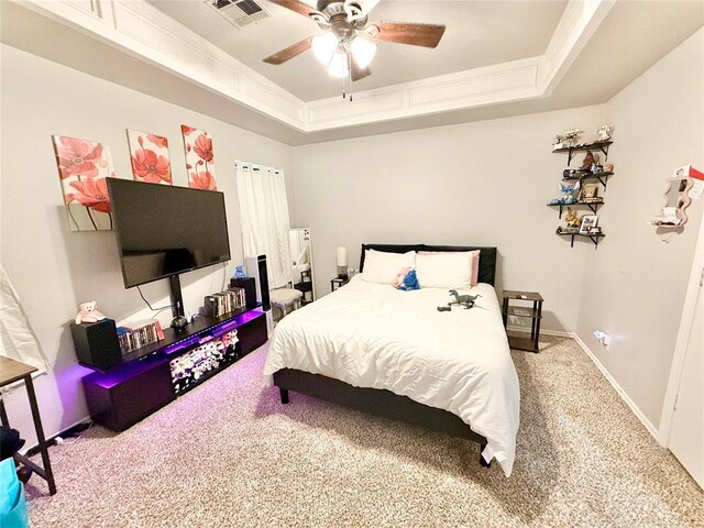 9977 Birkenhead Ct, Yukon, OK 73099 - carpeted bedroom with a tray ceiling, ornamental molding, and a ceiling fan