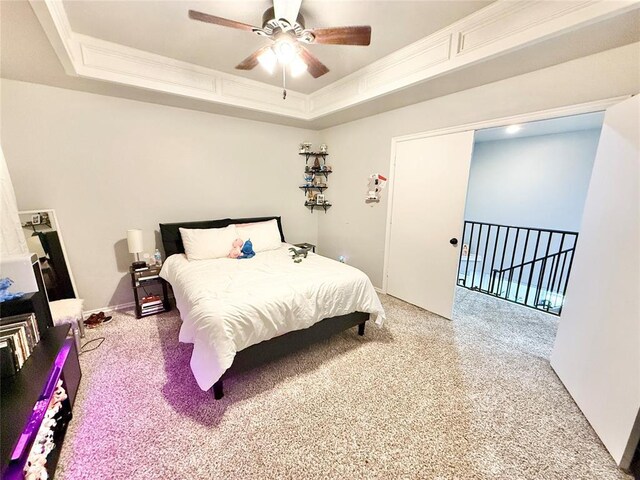9977 Birkenhead Ct, Yukon, OK 73099 - bedroom with light colored carpet, a tray ceiling, a ceiling fan, and crown molding