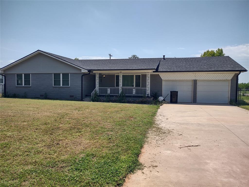 206 6th St, Verden, OK 73092 - single story home featuring covered porch, a garage, a front lawn, and driveway