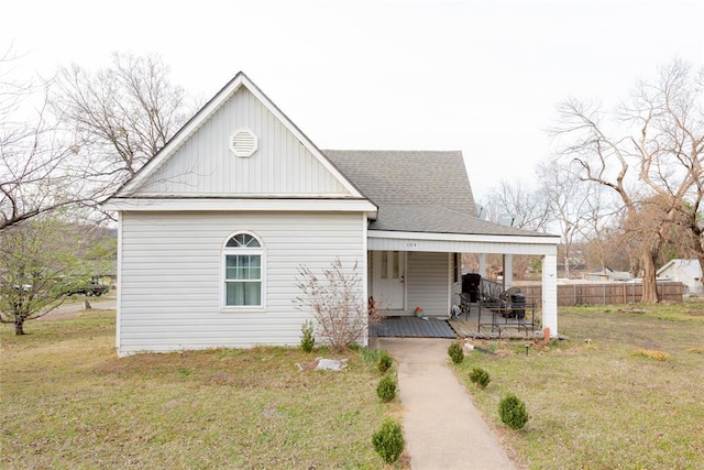 320 W Forest Ave, Eufaula, OK 74432 - view of front of house featuring a porch, a shingled roof, and board and batten siding