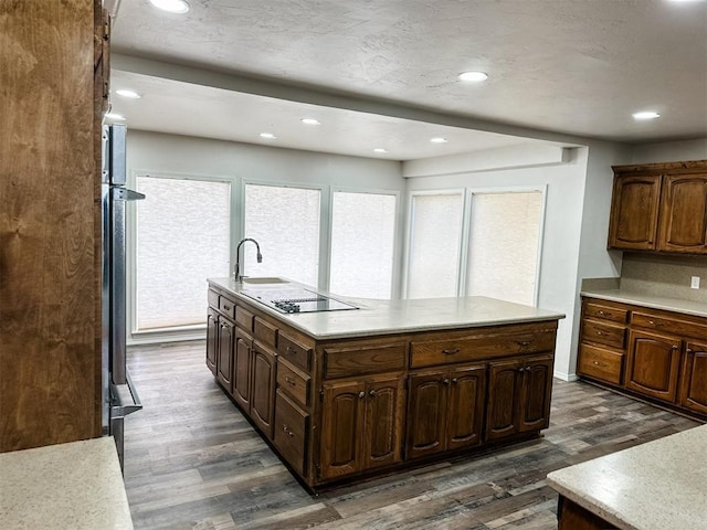 10190 County Road 1310, Fort Cobb, OK 73038 - kitchen featuring recessed lighting, black electric cooktop, a kitchen island with sink, dark wood finished floors, and light countertops