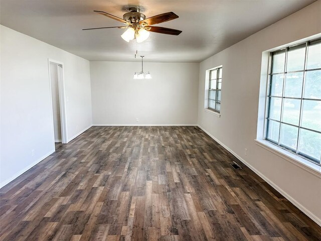 10190 County Road 1310, Fort Cobb, OK 73038 - spare room with a ceiling fan, a chandelier, dark wood-type flooring, and baseboards
