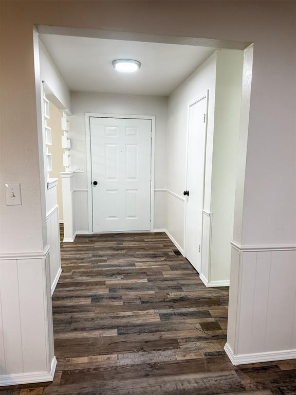 10190 County Road 1310, Fort Cobb, OK 73038 - corridor featuring dark wood finished floors and wainscoting