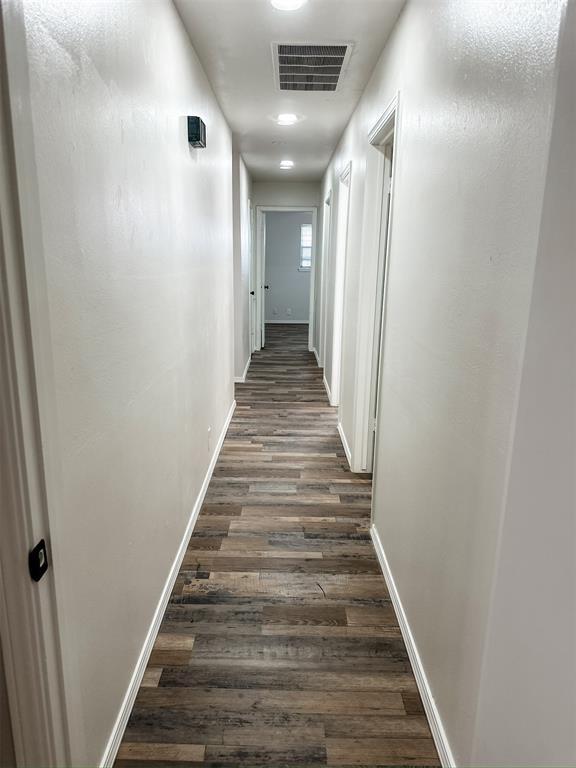 10190 County Road 1310, Fort Cobb, OK 73038 - hallway featuring dark wood-style floors and baseboards