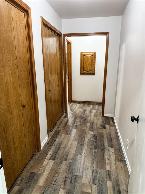 10190 County Road 1310, Fort Cobb, OK 73038 - hallway with dark wood-type flooring and baseboards
