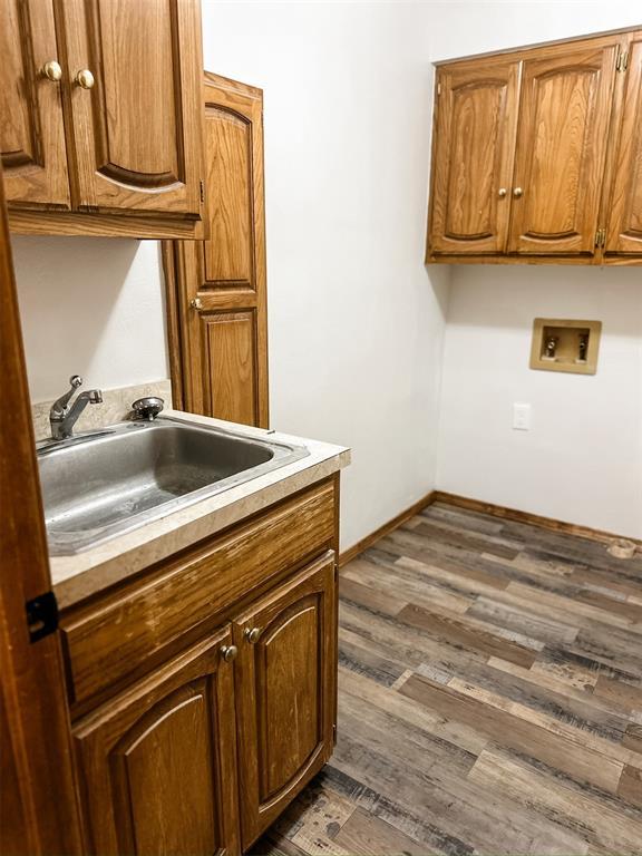10190 County Road 1310, Fort Cobb, OK 73038 - laundry room with cabinet space, hookup for a washing machine, and dark wood finished floors