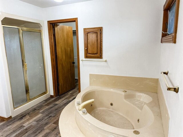 10190 County Road 1310, Fort Cobb, OK 73038 - bathroom featuring a stall shower, a whirlpool tub, and wood finished floors