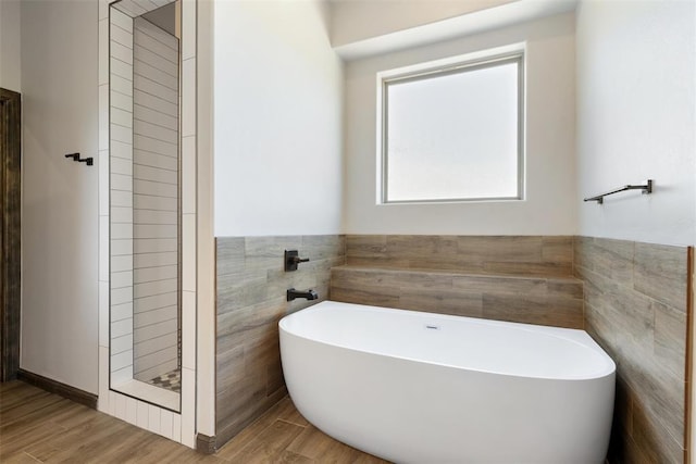 971 County St Unit 2983, Blanchard, OK 73010 - full bath with tile walls, a freestanding tub, wood finished floors, a wainscoted wall, and a tile shower