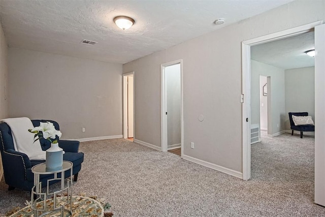 940 NE 32nd St, Oklahoma City, OK 73105 - sitting room featuring carpet and a textured ceiling
