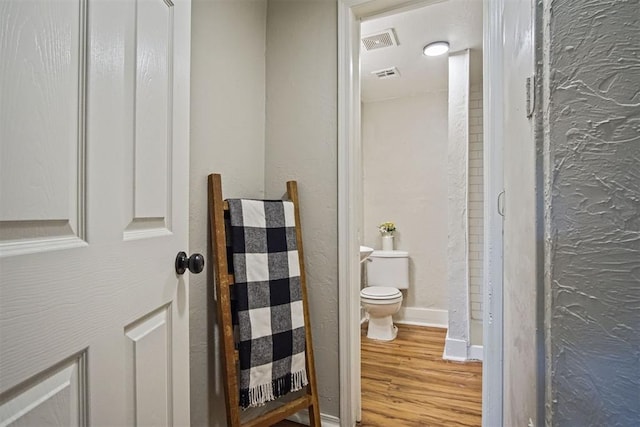 940 NE 32nd St, Oklahoma City, OK 73105 - bathroom featuring toilet and wood finished floors