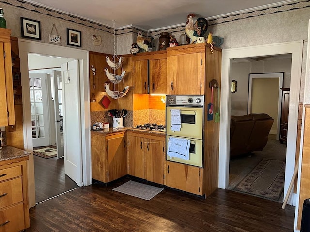 520 S Main St, Wetumka, OK 74883 - kitchen featuring double wall oven, dark wood-type flooring, gas cooktop, and brown cabinets