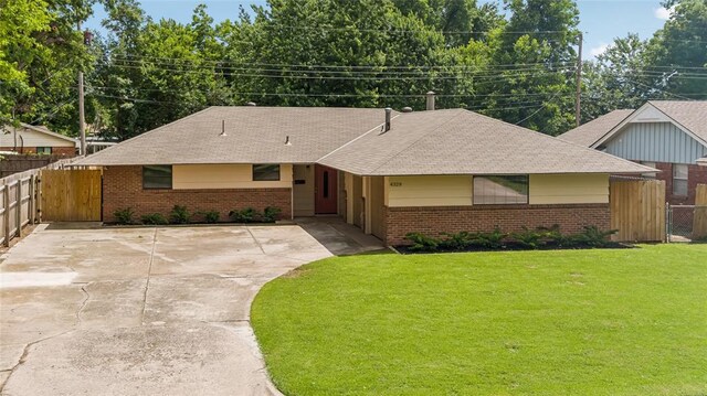 4328 NW 12th St, Oklahoma City, OK 73107 - ranch-style house featuring brick siding, concrete driveway, roof with shingles, and a gate