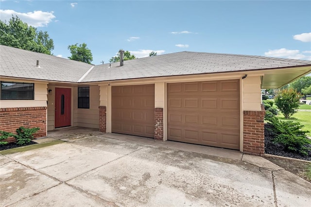 4328 NW 12th St, Oklahoma City, OK 73107 - ranch-style house with brick siding, concrete driveway, and an attached garage