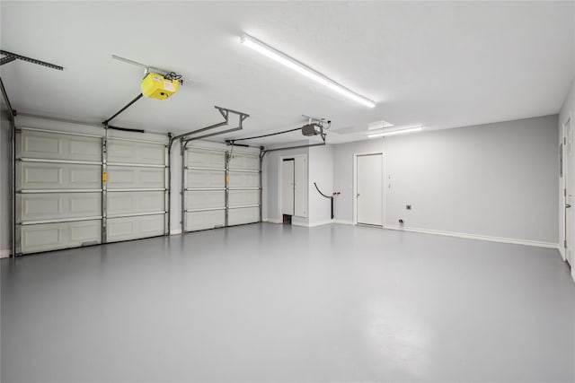 4328 NW 12th St, Oklahoma City, OK 73107 - garage featuring a garage door opener and baseboards