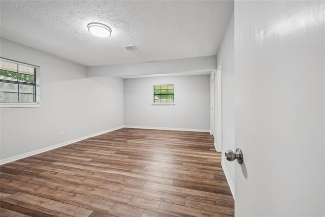 4328 NW 12th St, Oklahoma City, OK 73107 - empty room featuring a textured ceiling, wood finished floors, and baseboards