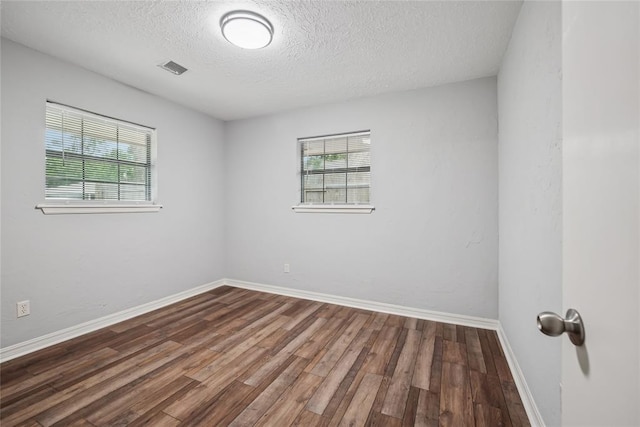 4328 NW 12th St, Oklahoma City, OK 73107 - spare room featuring plenty of natural light, a textured ceiling, wood finished floors, and baseboards