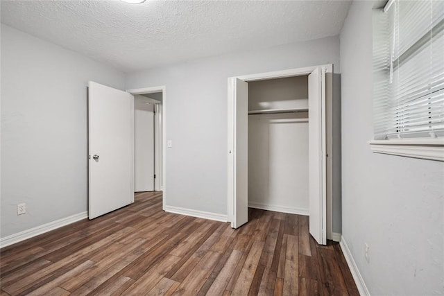 4328 NW 12th St, Oklahoma City, OK 73107 - unfurnished bedroom with wood finished floors, baseboards, a closet, and a textured ceiling