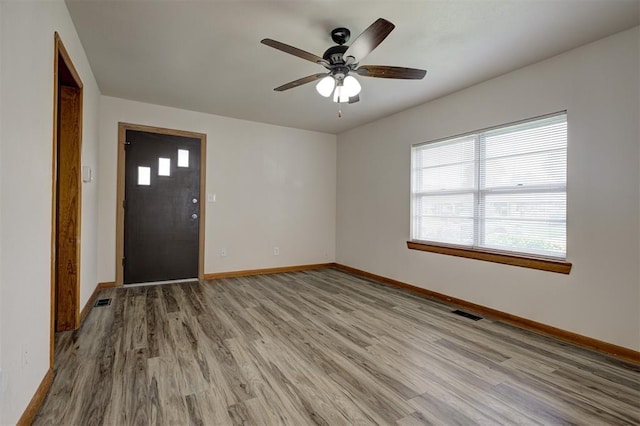 520 SE 47th St, Oklahoma City, OK 73129 - spare room featuring plenty of natural light, wood finished floors, baseboards, and a ceiling fan